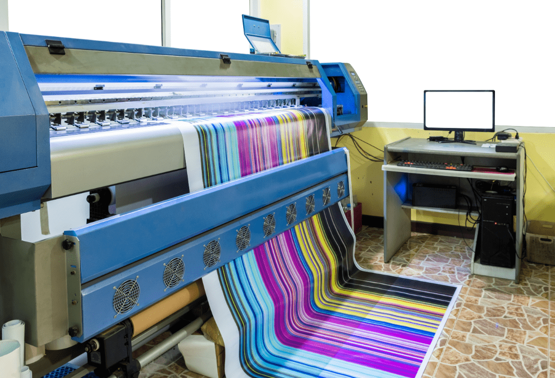 A large printer, printing a large featured image with lots of different colours 